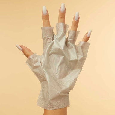 Hand wearing Voesh collagen glove hand mask with mint and botanical extracts