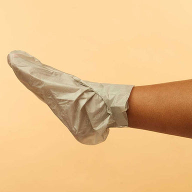 Foot wearing VOESH New York Collagen Socks moisturizing foot mask for heel and foot care