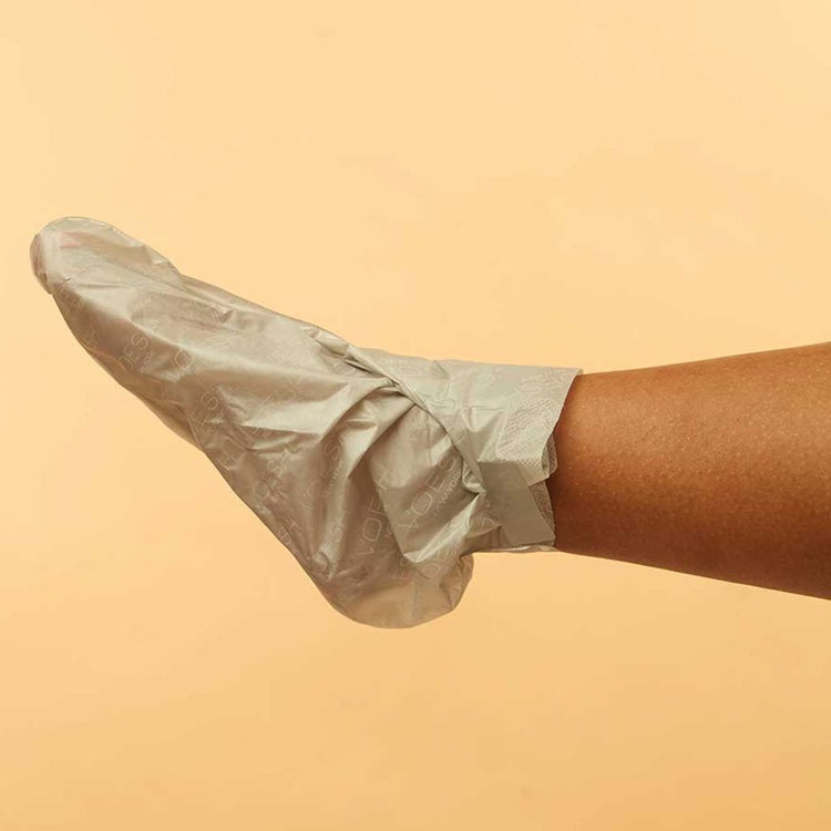 Foot wearing VOESH New York Collagen Socks moisturizing foot mask for heel and foot care