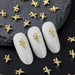 Nail Success Australia cross star rhinestone nail charms — gold 3D embellishments shown on white tips