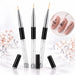 Three nail art liner brushes with crystal-filled handles and black protective caps, shown with black floral designs on pink nail swatches.
