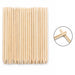 Wooden cuticle pusher sticks with large angled flat ends and pointed tips, shown in a clear hanging plastic bag