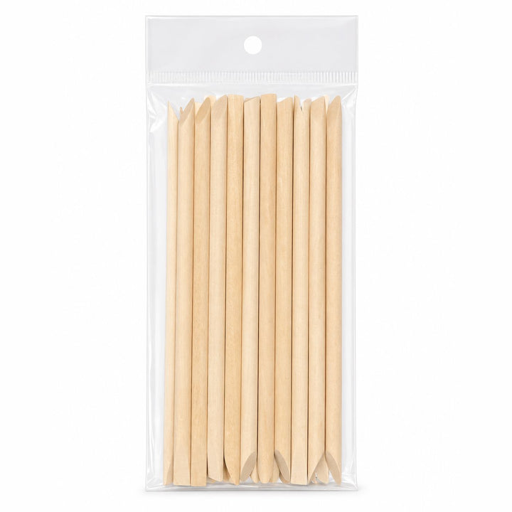Pack of wooden cuticle pusher sticks with large angled flat ends and pointed tips in clear hanging plastic bag packaging