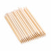 Wooden cuticle pusher sticks stacked diagonally, showing pointed tips and angled flat ends on a light gray background