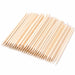 Wooden cuticle pusher sticks arranged in a fan shape, showing pointed tips and angled flat ends on a light gray background