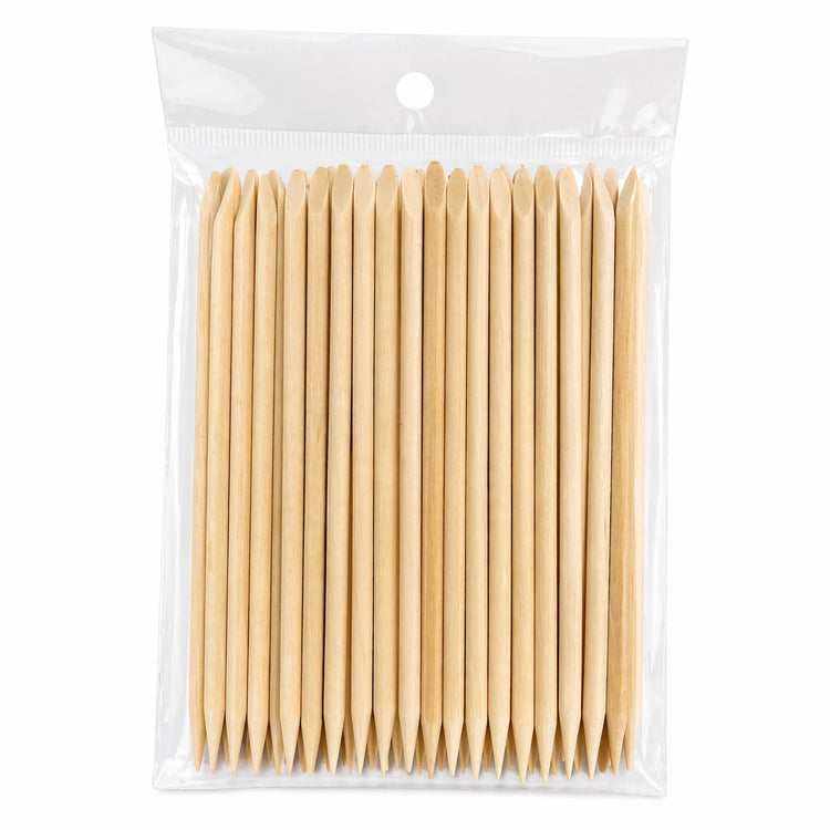 Bulk pack of wooden cuticle pusher sticks in a clear hanging plastic bag, showing angled flat ends and pointed tips on a light gray background