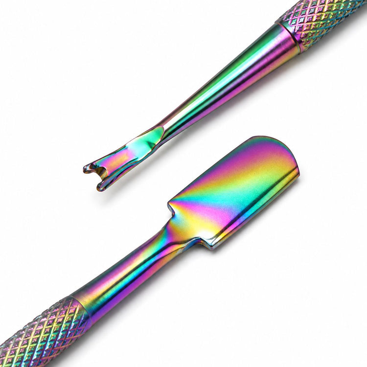 Close-up of rainbow cuticle trimmer and pusher tool showing dual ends and textured grip for manicure prep