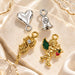 Gold and silver dangle nail charms including a cupid, rose, heart and bell