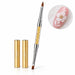 Gold double-ended nail art brush with pointed and flat tips, crystal-filled handle and two protective caps, shown with white 3D floral nail art.
