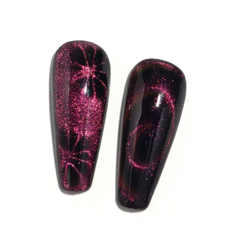 Black false nail tips with pink cat eye magnetic gel polish, floral and swirl effects for showcasing magnetic nail art designs