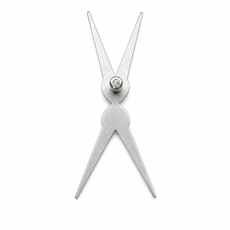 Silver scissor-shaped double-headed cat-eye magnet tool shown flat on a white background