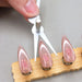 Scissor-shaped double-ended cat eye magnet tool shaping pink magnetic gel cat-eye nails on nail stand