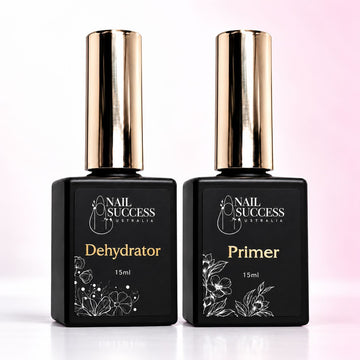 Nail Success Australia Dehydrator and Nail Primer duo, two 15ml black bottles with gold caps on a soft pink background