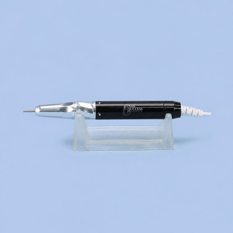 Black electric nail file handpiece with silver drill bit on clear stand – Nail Success Australia