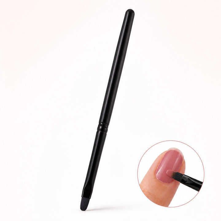 Black gel nail brush with oval bristles for solid gels and polishes, shown applying dusty pink gel to a nail.
