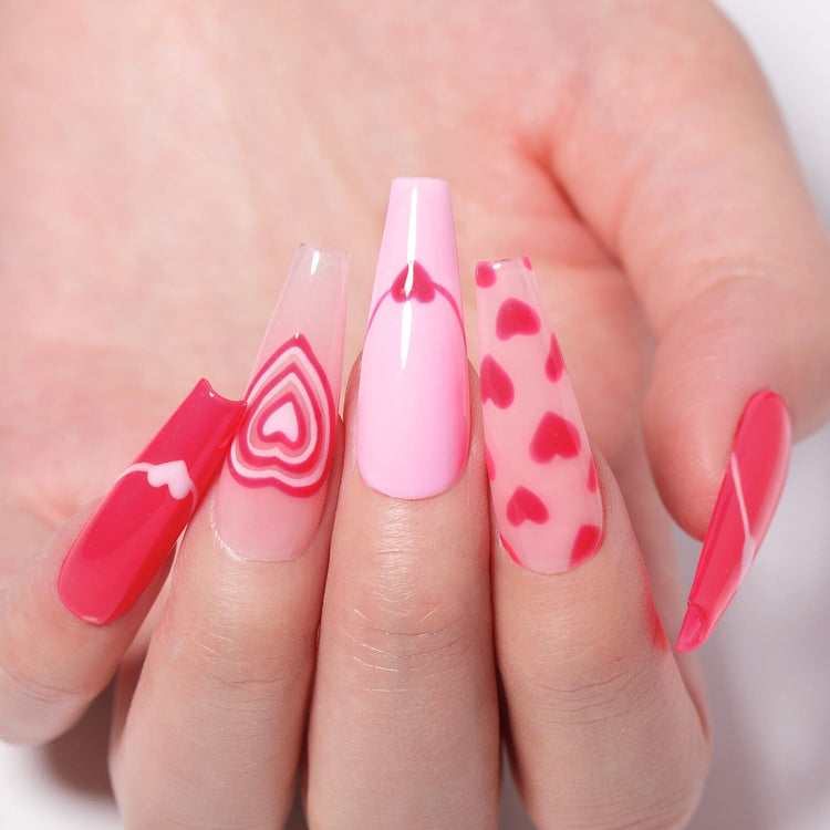 Valentine pink heart nail art on long coffin nails—jelly red, aura hearts, and glossy pink gel polish