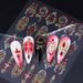 Gothic nail art sticker sheet with red, white and gold ornamental decals shown on example long stiletto nail designs