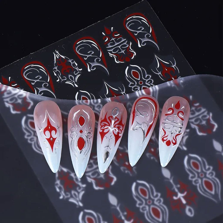 White, red and silver gothic nail art sticker sheet shown with example long nail designs