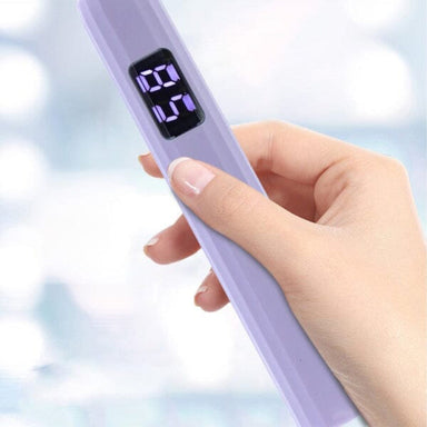 Hand holding a lavender USB rechargeable LED nail torch with a digital timer display