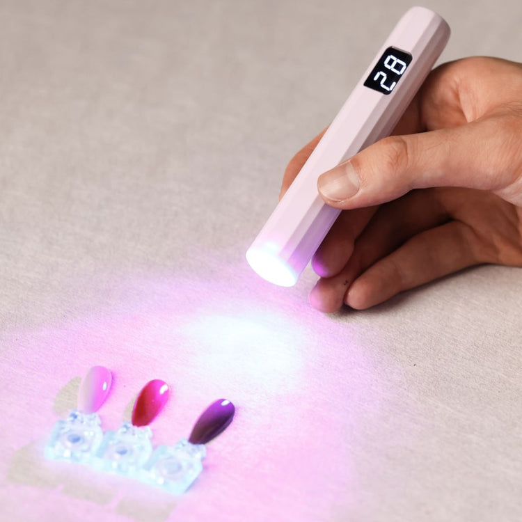 USB-rechargeable LED nail flash-cure torch with digital timer—handheld pen lamp curing gel polish swatches by Nail Success Australia