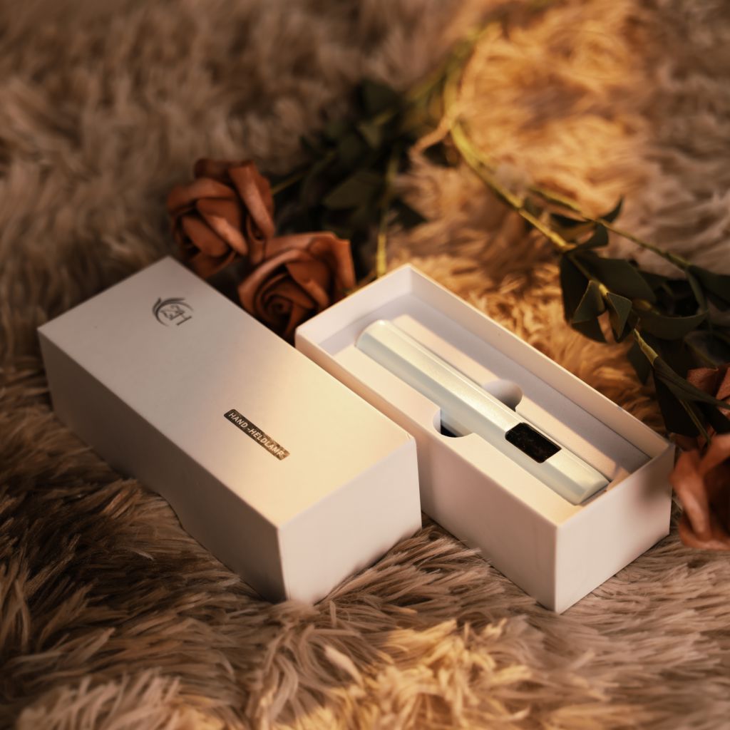 USB-rechargeable LED nail flash-cure torch in box—pen-style lamp for gel tips by Nail Success Australia, lifestyle with roses