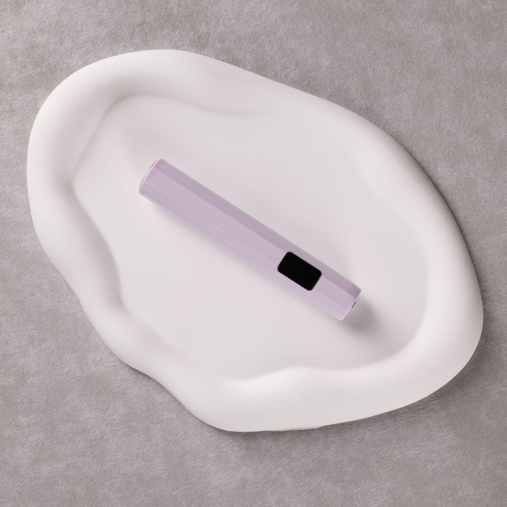 USB-rechargeable LED nail flash-cure torch—lavender pen-style lamp for gel tips by Nail Success Australia on a white tray