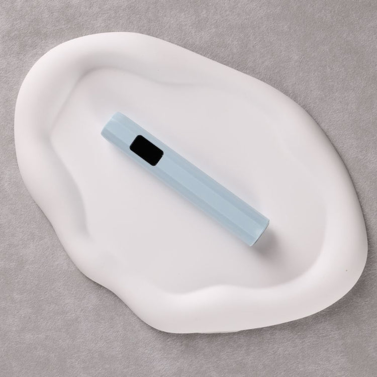USB-rechargeable LED nail flash-cure torch—sky-blue pen-style lamp with display on white tray by Nail Success Australia