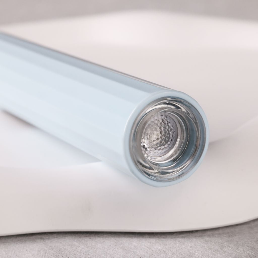 USB-rechargeable LED nail flash-cure torch—close-up of lamp head and reflector, sky-blue pen-style by Nail Success Australia
