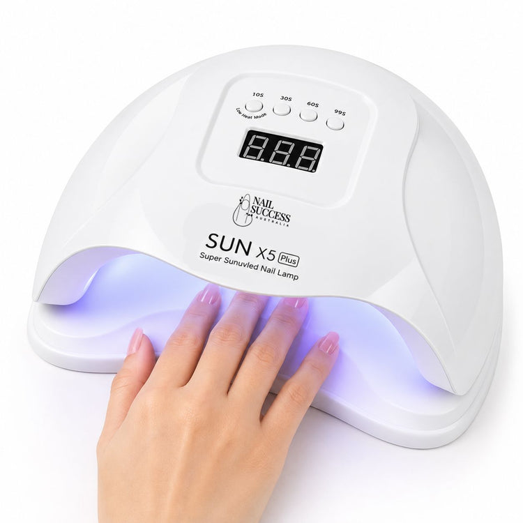 White 80W LED UV nail lamp with digital timer curing gel polish on a manicured hand