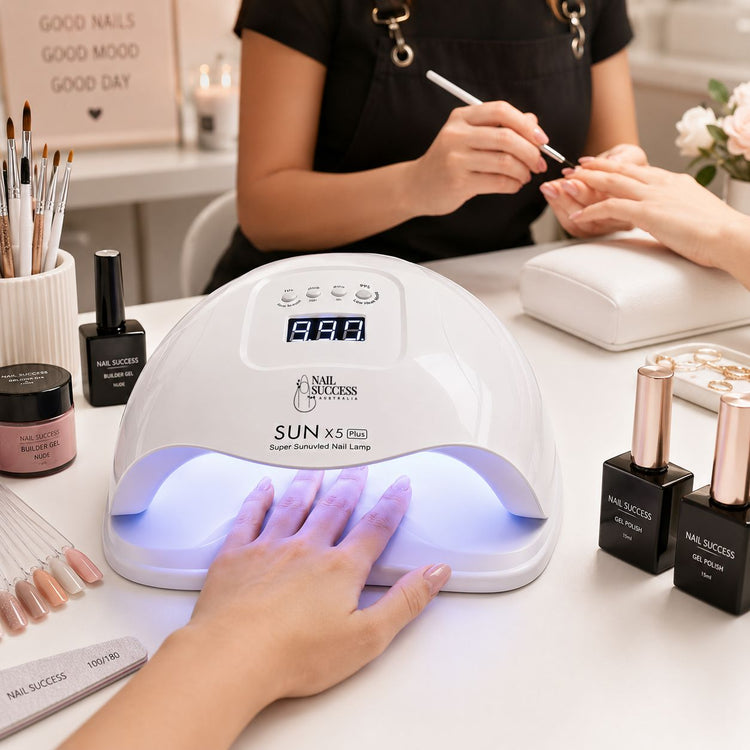 Professional white 80W UV LED nail lamp curing gel polish during a salon manicure