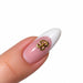Gold script letter B nail art charm on a pink French tip almond nail