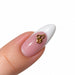 Gold script letter C nail art charm on a pink French tip almond nail