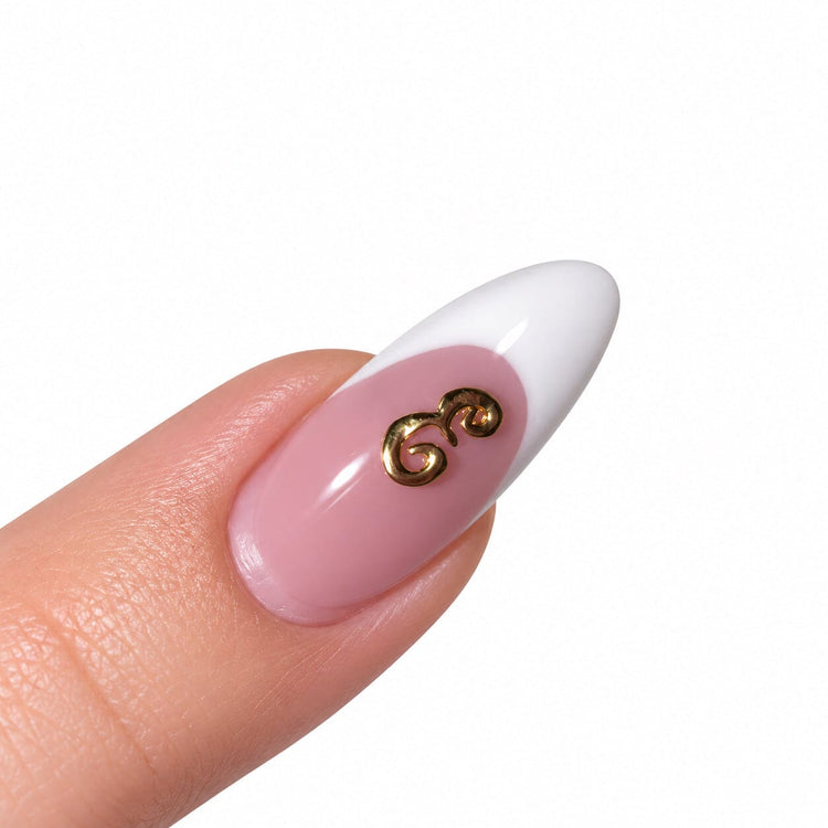 Gold script letter E nail art charm on a pink French tip almond nail