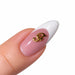 Gold script letter F nail art charm on a pink French tip almond nail