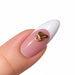 Gold script letter G nail art charm on a pink French tip almond nail