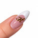 Gold script letter H nail art charm on a pink French tip almond nail