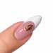 Gold script letter I nail art charm on a pink French tip almond nail