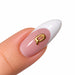 Gold script letter Q nail art charm on a pink French tip almond nail