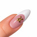 Gold script letter U nail art charm on a pink French tip almond nail