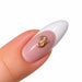 Gold script letter Y nail art charm on a pink French tip almond nail