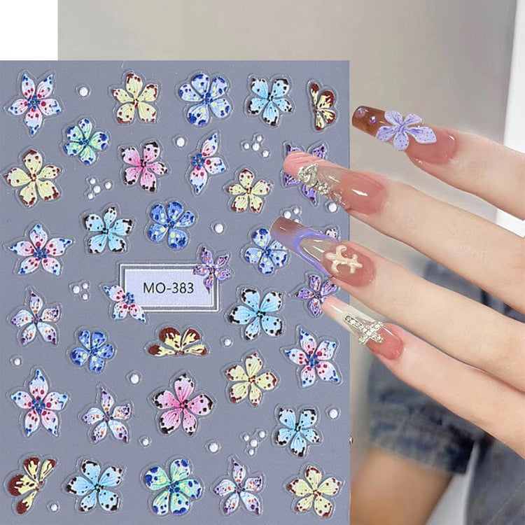 MO-383 Lily and Hibiscus Flower Nail Art Sticker sheet with blue, pink, yellow and white floral designs on manicure sample