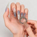 Manicured hand holding 20-piece 5 mm magnetic beads for blooming cat-eye gel polish nail art – NSI Australia