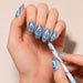 Blue marbled cat-eye magnetic pen creating spiral effects on blue magnetic gel polish nails – NSI Australia