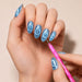 Pink marbled cat-eye magnetic pen creating spiral nail art on blue magnetic gel polish – NSI Australia