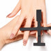 Black multi-shape cat-eye magnet tool positioned over natural nails for creating magnetic gel polish effects