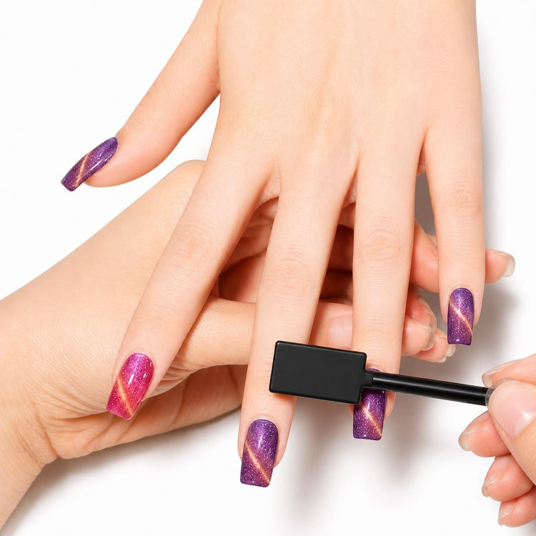 Rectangular cat-eye nail magnet tool creating luminous diagonal patterns in purple and pink magnetic gel polish