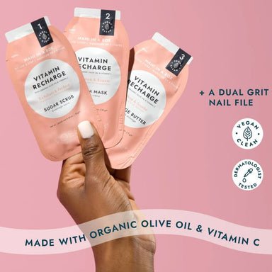Hand holding VOESH New York Mani in a Box Vitamin Recharge 3-step manicure sachets with dual grit nail file