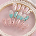 Metallic 3D alphabet nail art letters on pink and teal gel nails, personalized names with pearls and rhinestones display
