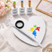Heart-shaped stainless steel nail art mixing palette with double-ended spatula tool and gel polish colours for professional salon nail designs