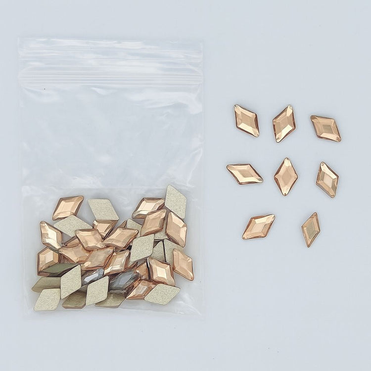 Gold diamond-shaped nail art rhinestones — zip bag with loose sample pieces (NSI Australia)